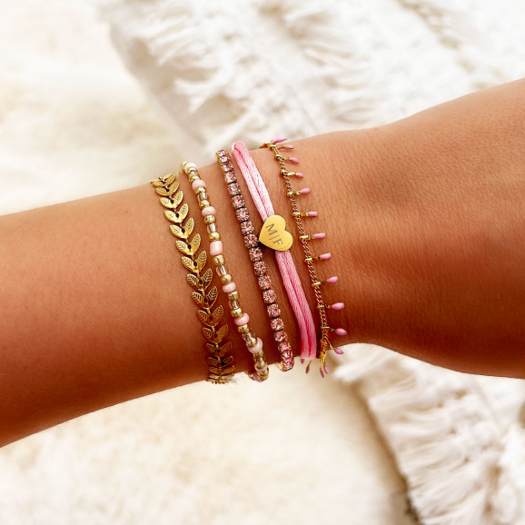 Gouden armparty met roze en gouden armbanden