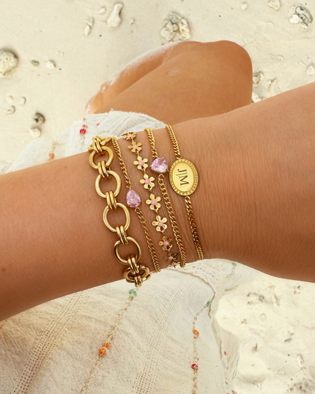 Gouden armparty met roze steentjes