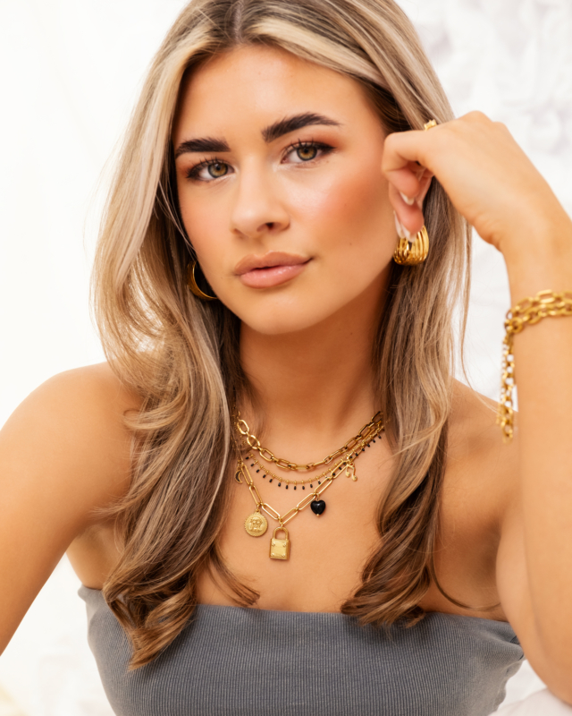 Model draagt gouden sieraden