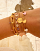 Gouden armparty met roze en paarse details