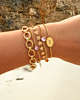 Gouden armparty met roze details