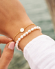 Gouden armparty met witte details