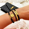 Gouden armparty met zwarte details