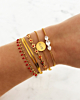 Gouden armparty met rode details