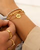 Gouden armparty met tennis en chains