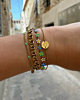 Gouden armparty met groene details