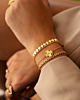 Gouden armparty met clovers