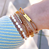 Goudkleurige armparty met goud en parels