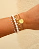 Gouden armparty met witte touch